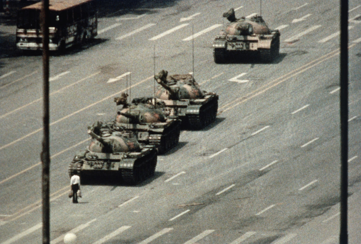 A Beijing demonstrator blocks the path of a tank convoy along the Avenue of Eternal Peace near Tiananmen Square. 
Photo by Bettmann via Getty Images.